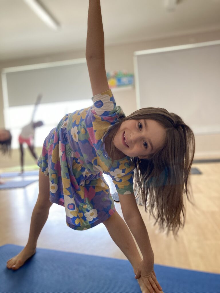 Wellbeing and yoga being completed by early learning child