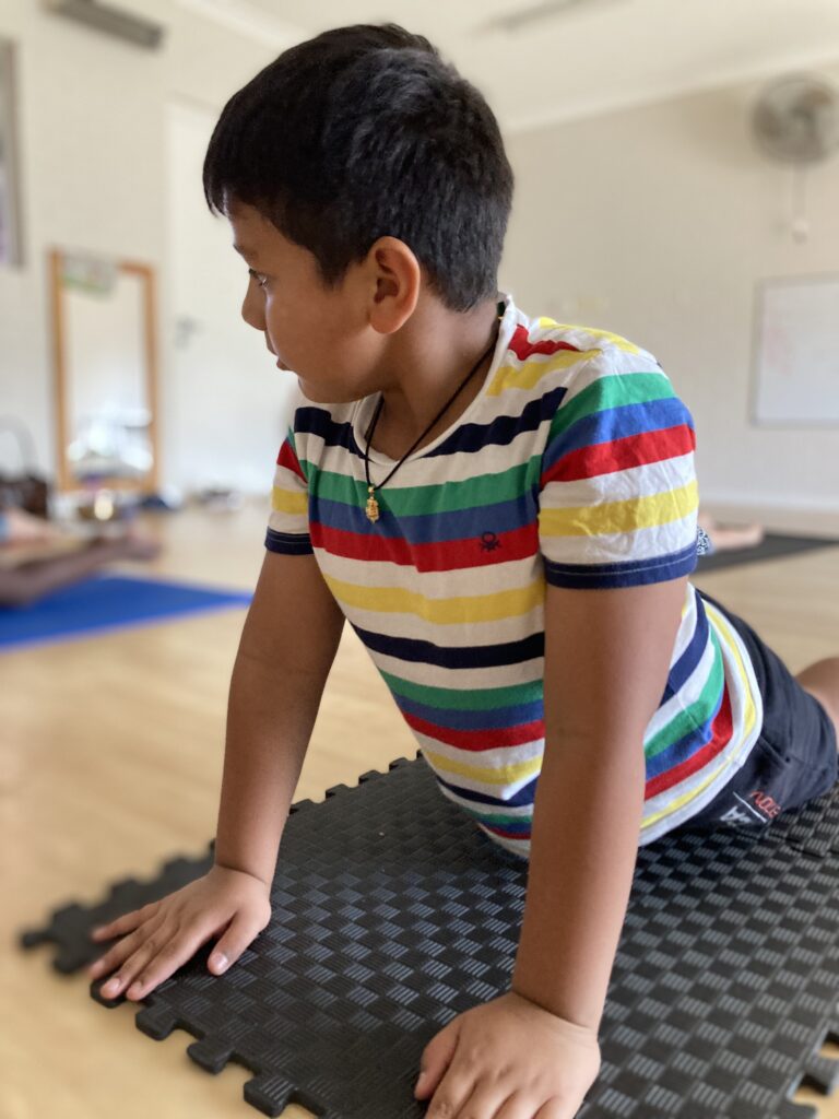 Wellbeing and yoga being completed by early learning child