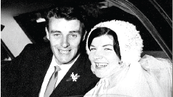 A black and white picture of a couple on their wedding day