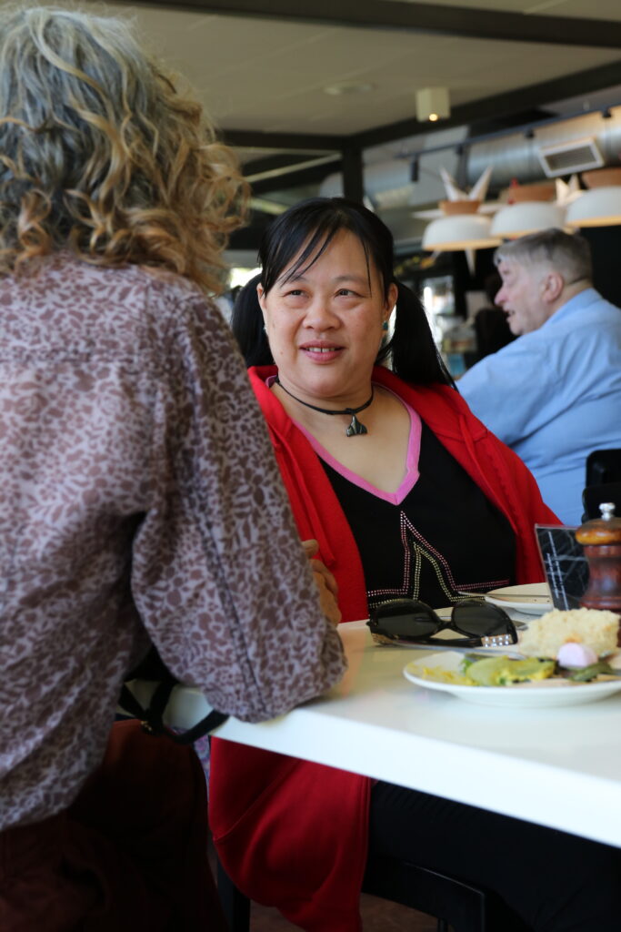 Participant smiling with support worker 